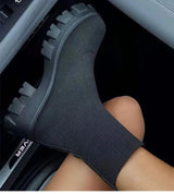 BootyComfort Women’s Casual Fashion Sneakers in black worn in a car seat, featuring a stylish slip-on design.