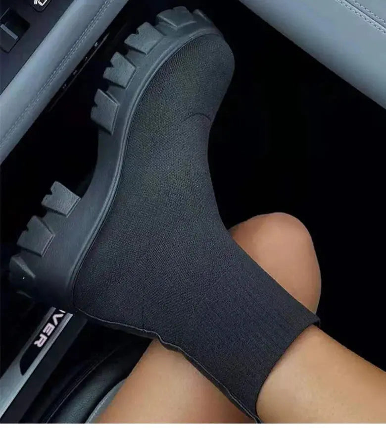BootyComfort Women’s Casual Fashion Sneakers in black worn in a car seat, featuring a stylish slip-on design.